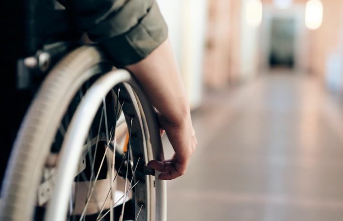A person in a wheelchair is standing on the floor