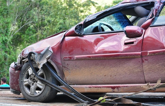 A car that has been hit by a truck.