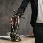 A person holding onto the handle of a statue