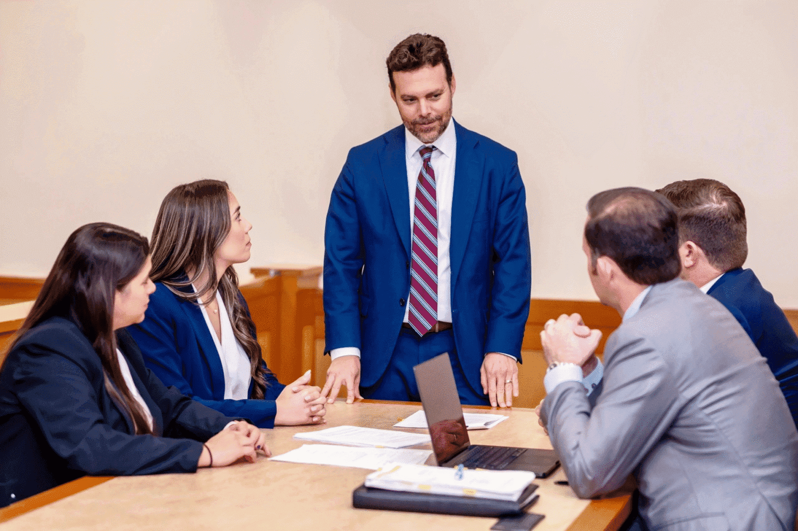 Business meeting with five professionals discussing.