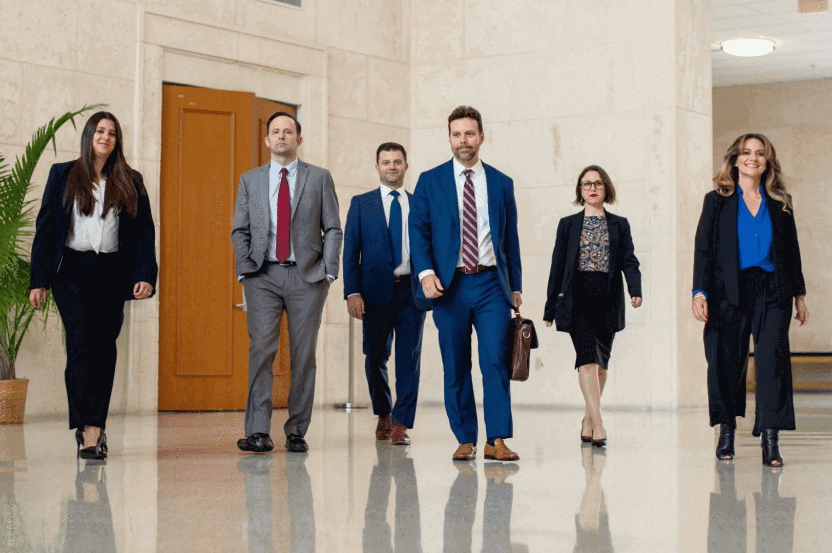 Business professionals walking in a hallway confidently.