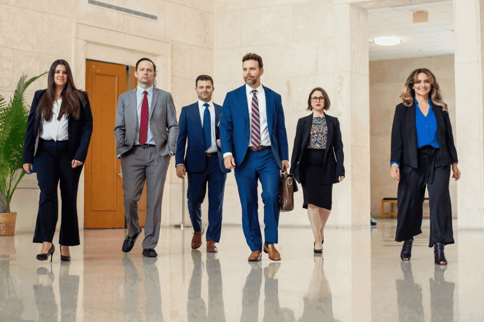 Professionals walking confidently in business attire.