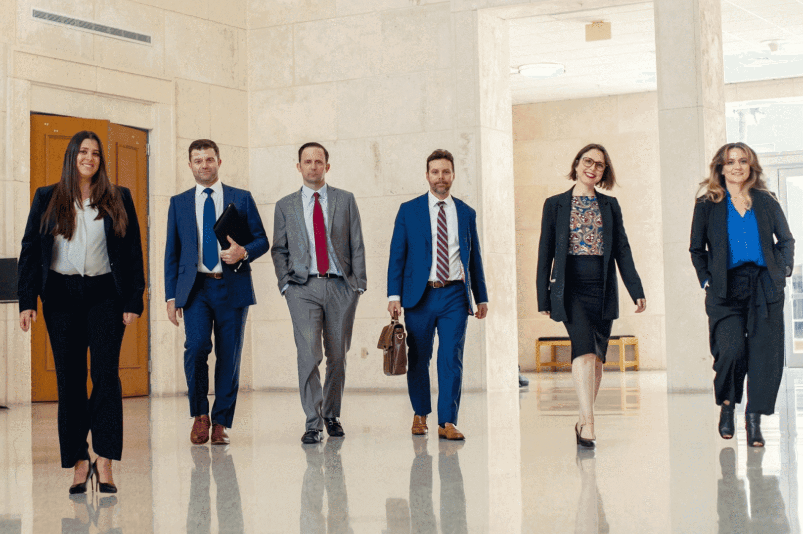 Group of professionals walking in hallway.